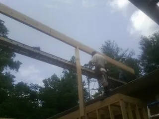 Carpenter setting a ridge beam over a new addition frame — Ice Dam Removal by Roofing Brothers in Ririe