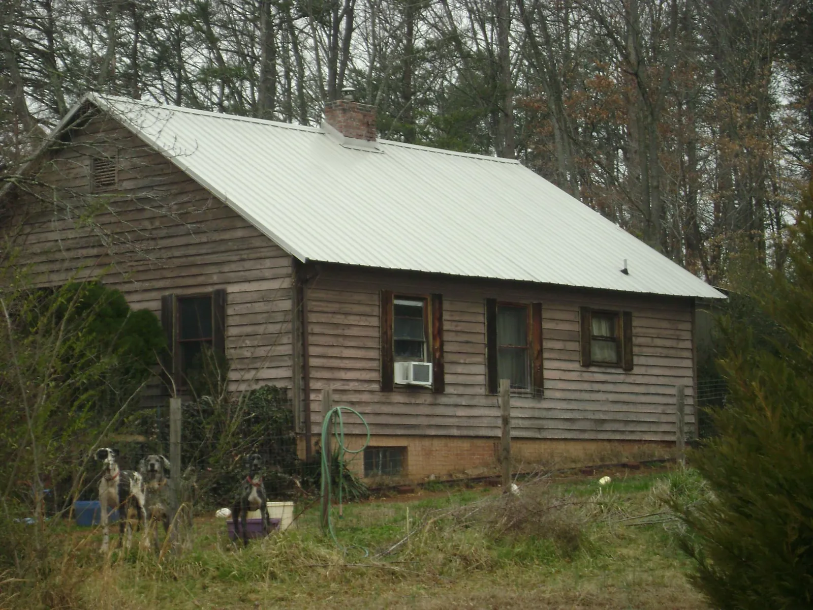 White metal roof on an old wood sided farmhouse, from a Metal Roof Installation job in Ririe